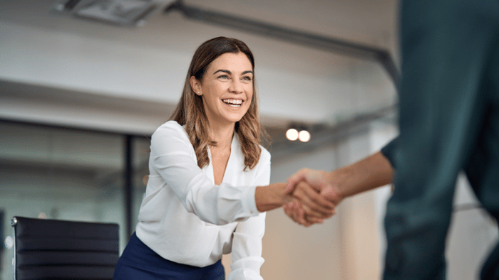 Female customer shaking hands with salesperson