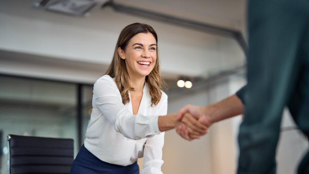 Female customer shaking hands with salesperson